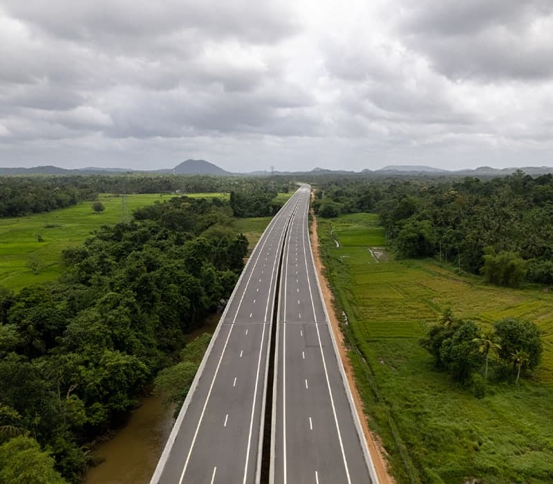 Aerial view of the Southern Expressway running between paddy fields and forest